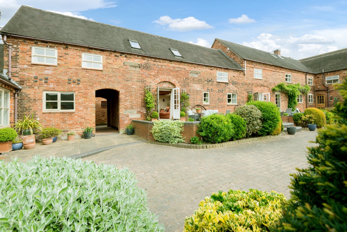 Upper Rectory Farm Cottages - lovely courtyard setting with mature shrubs
